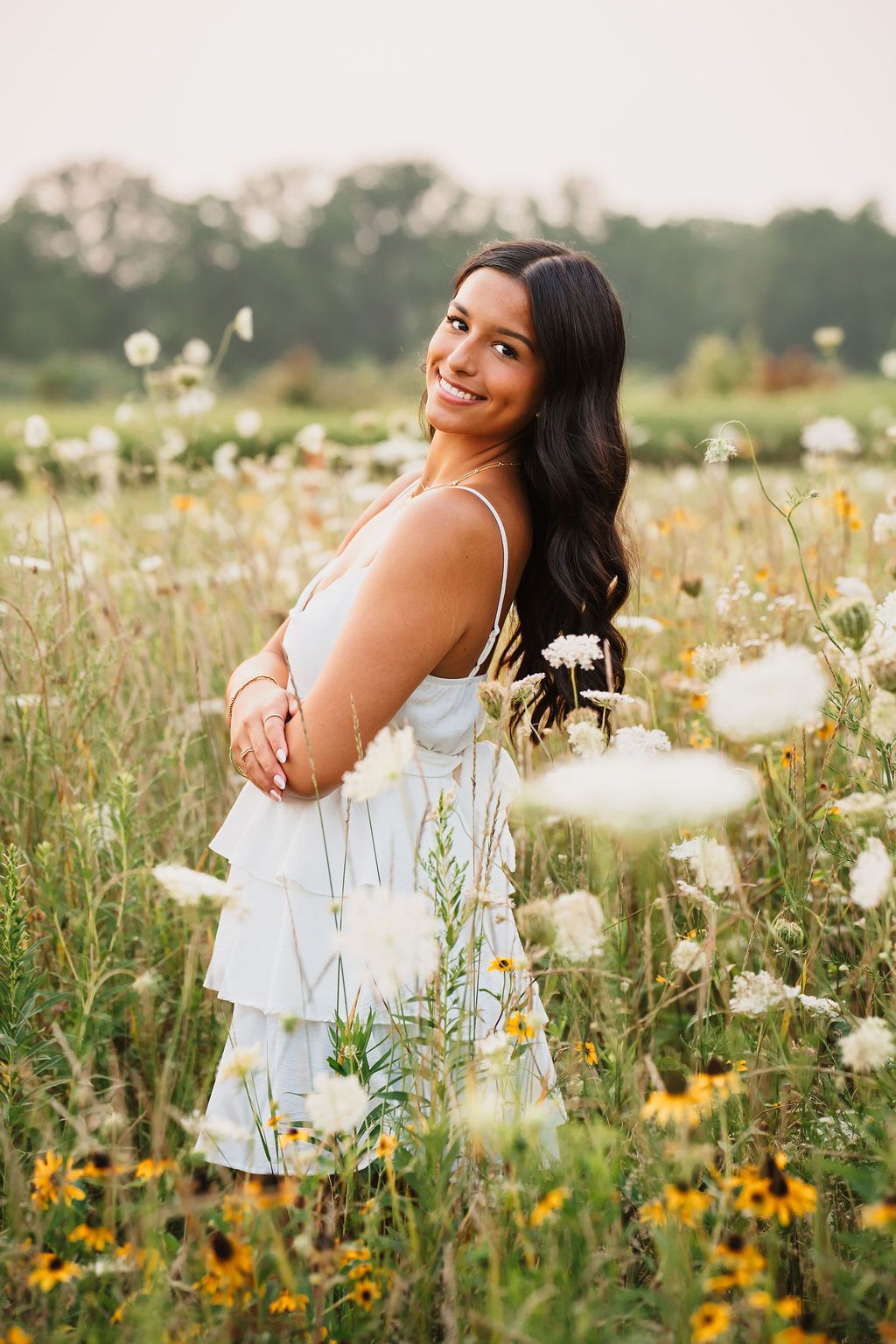 Dreamy outdoor photography in a wildflower meadow at sunset with white and yellow blooms.