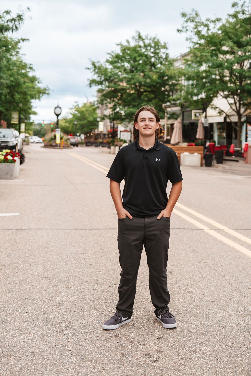 A series of photos showing a person in a black polo shirt and dark pants standing in an empty street or parking lot.