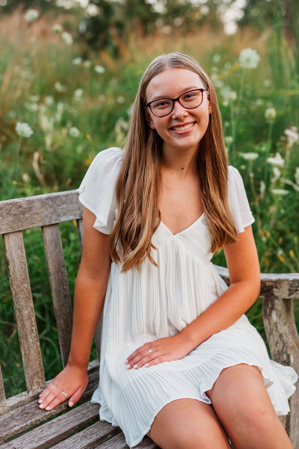 A series of outdoor portrait shots on a wooden bench surrounded by wildflowers in summer lighting.