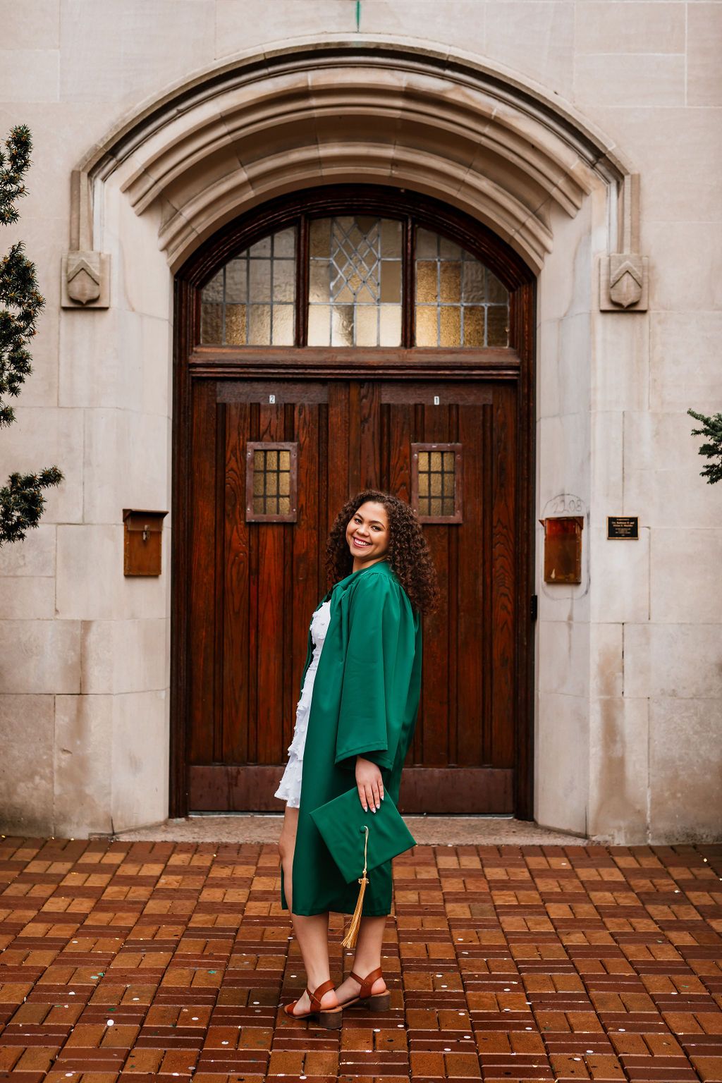 A series of photos showing someone in an emerald green coat posing in front of an arched wooden church doorway.