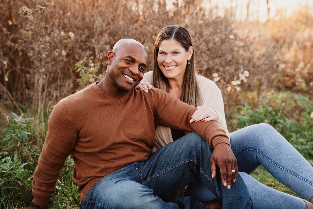 Casual outdoor couple photography session in a rustic field during golden hour.