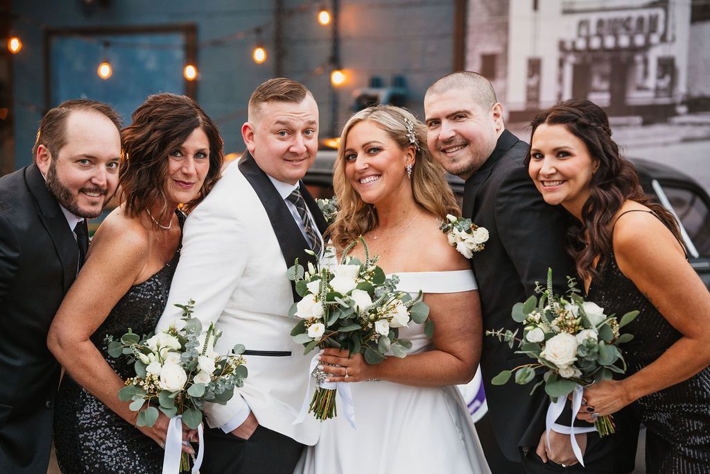 A wedding party celebrates with joy and laughter in a series of candid black and white photographs.