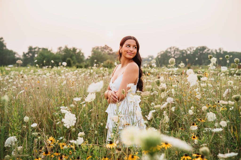 Candid photography in a blooming wildflower field with white cosmos and yellow flowers.