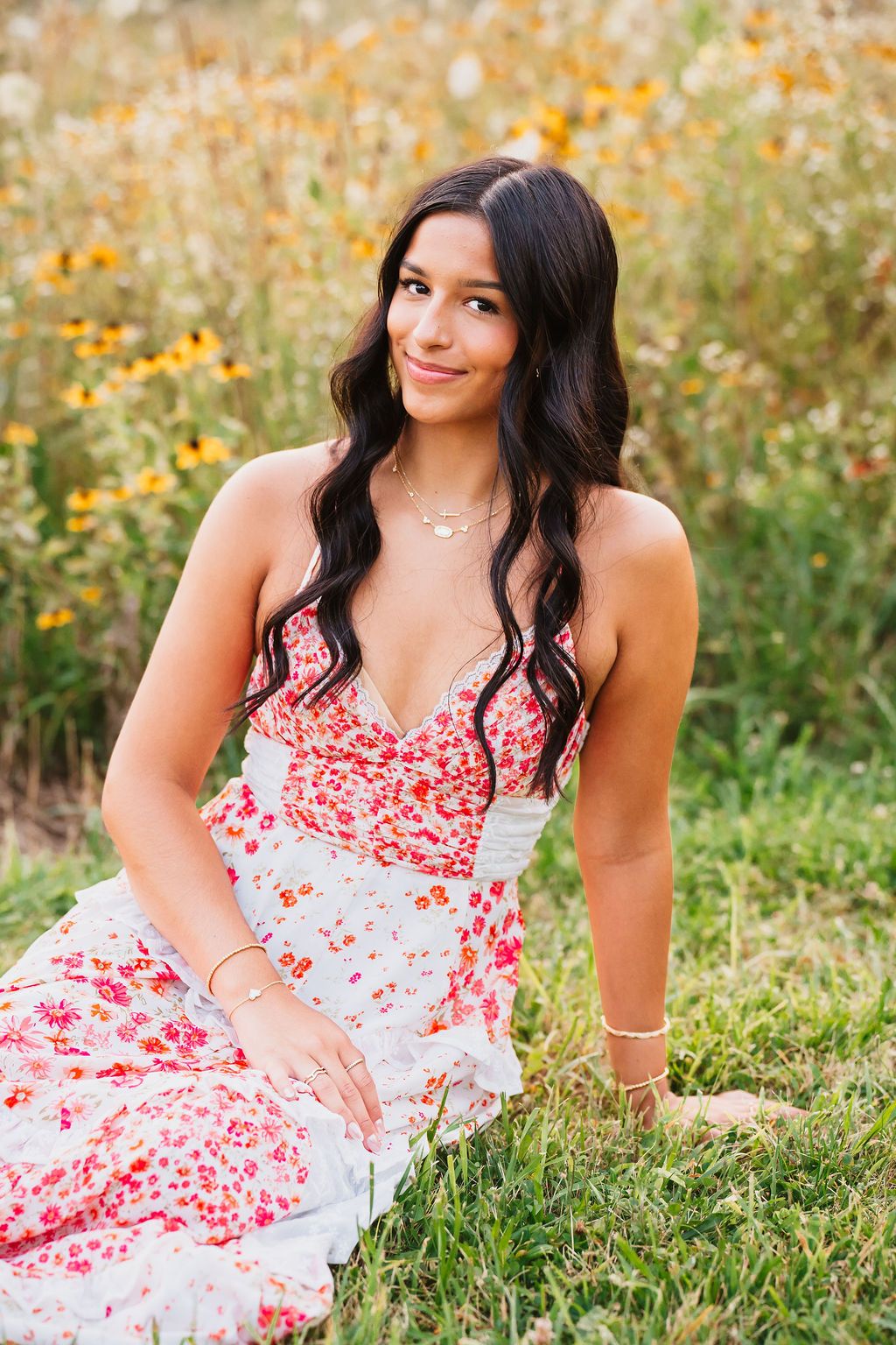 A floral sundress stands out against a natural backdrop of yellow wildflowers and green grass.