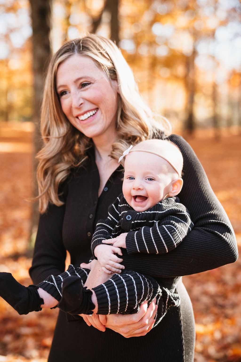 Heartwarming autumn photoshoot capturing joyful moments in warm golden sunlight.