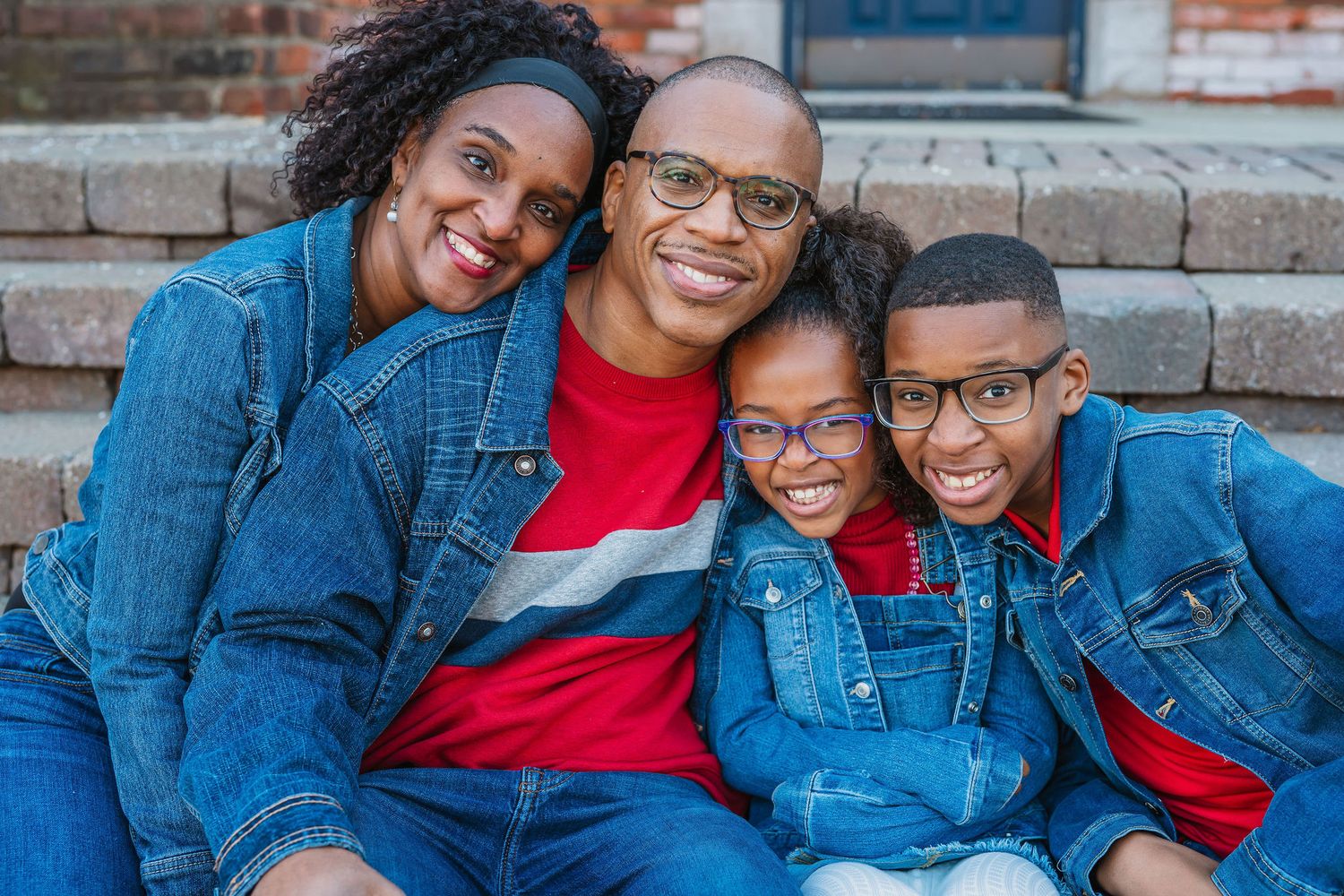 Casual urban family photography featuring coordinated denim and red outfits.