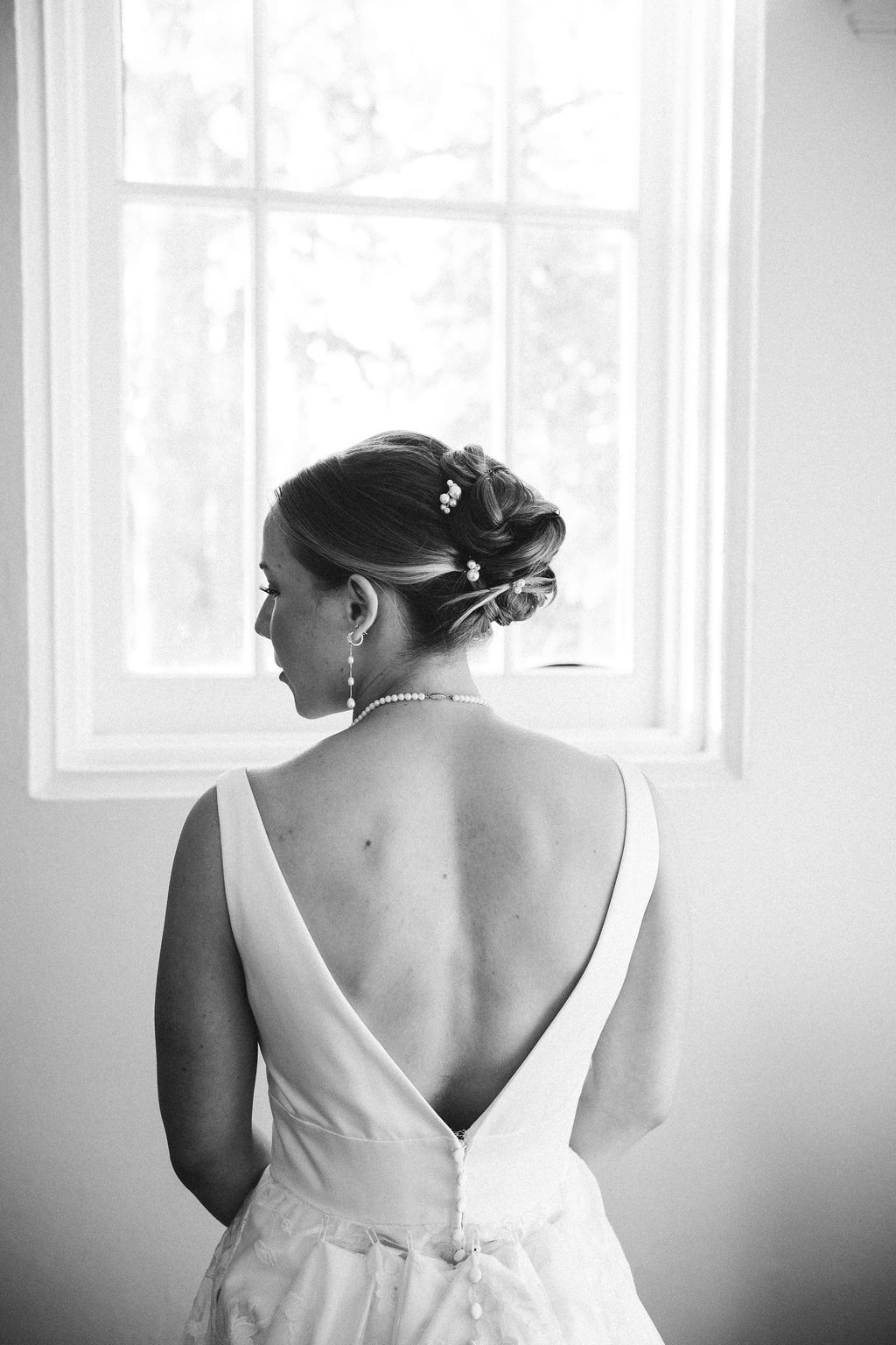 Black and white bridal portraits showing elegant wedding dress details in natural window light.