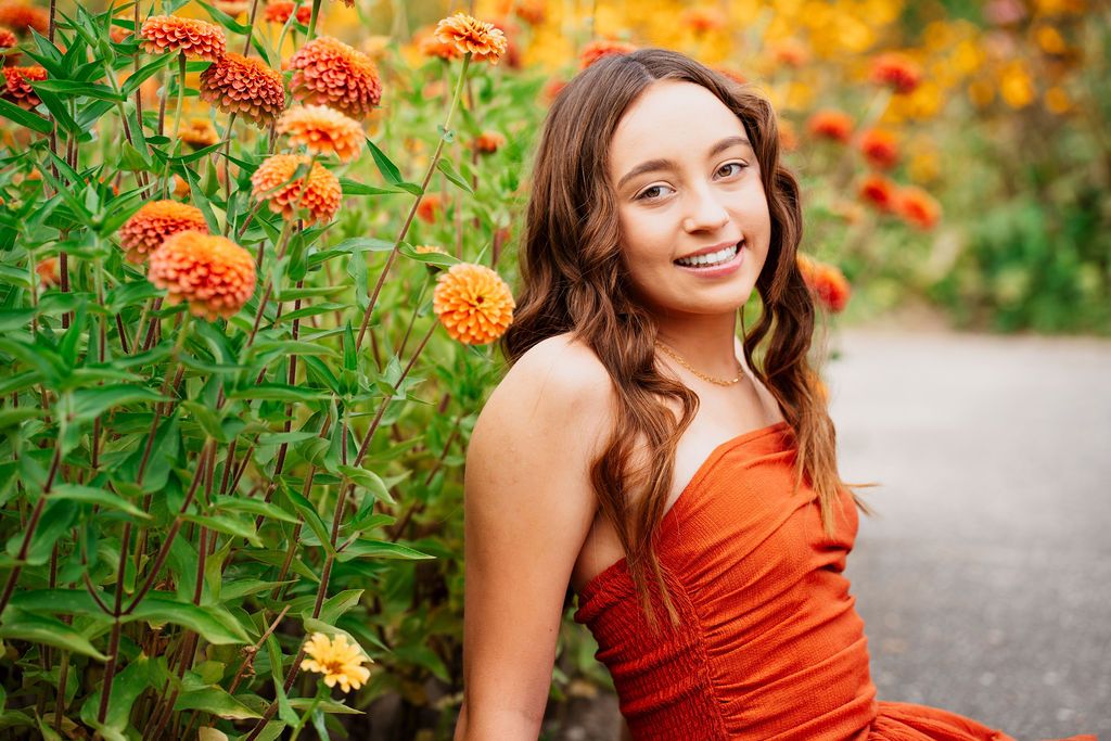 A series of outdoor portraits in an orange dress against vibrant autumn foliage and garden backgrounds.