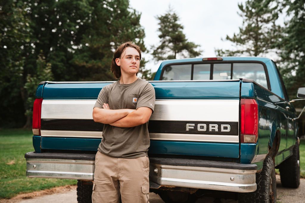 Multiple views of someone posing casually against a vintage Ford pickup truck in a rural landscape.