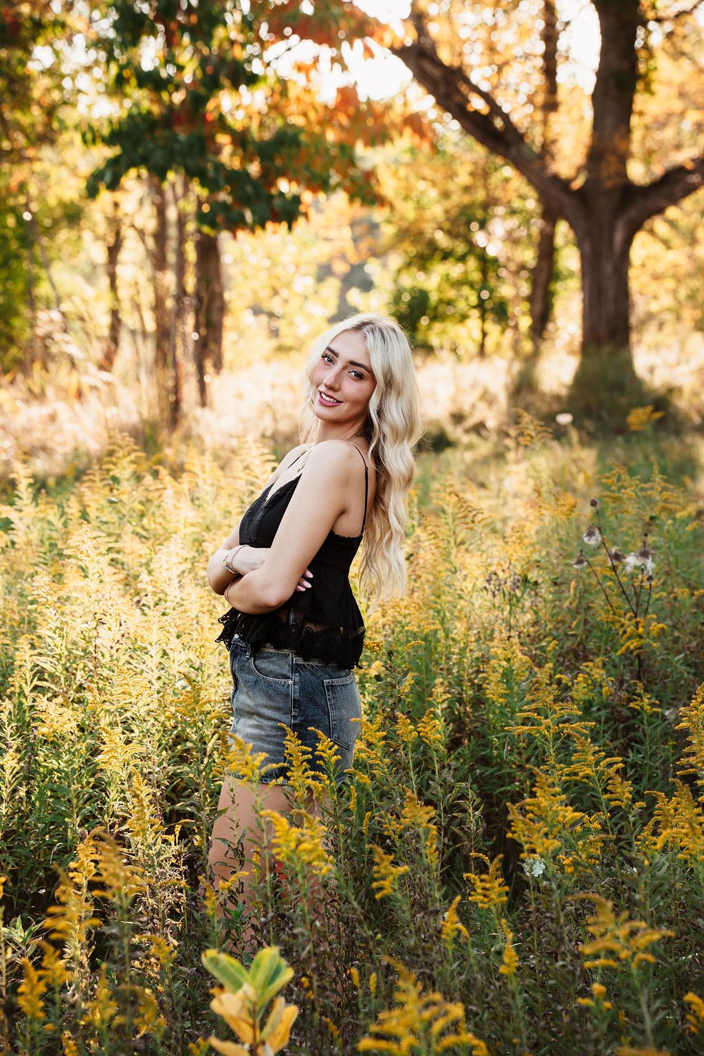 A series of outdoor portraits in a golden meadow with yellow wildflowers and trees during sunset.