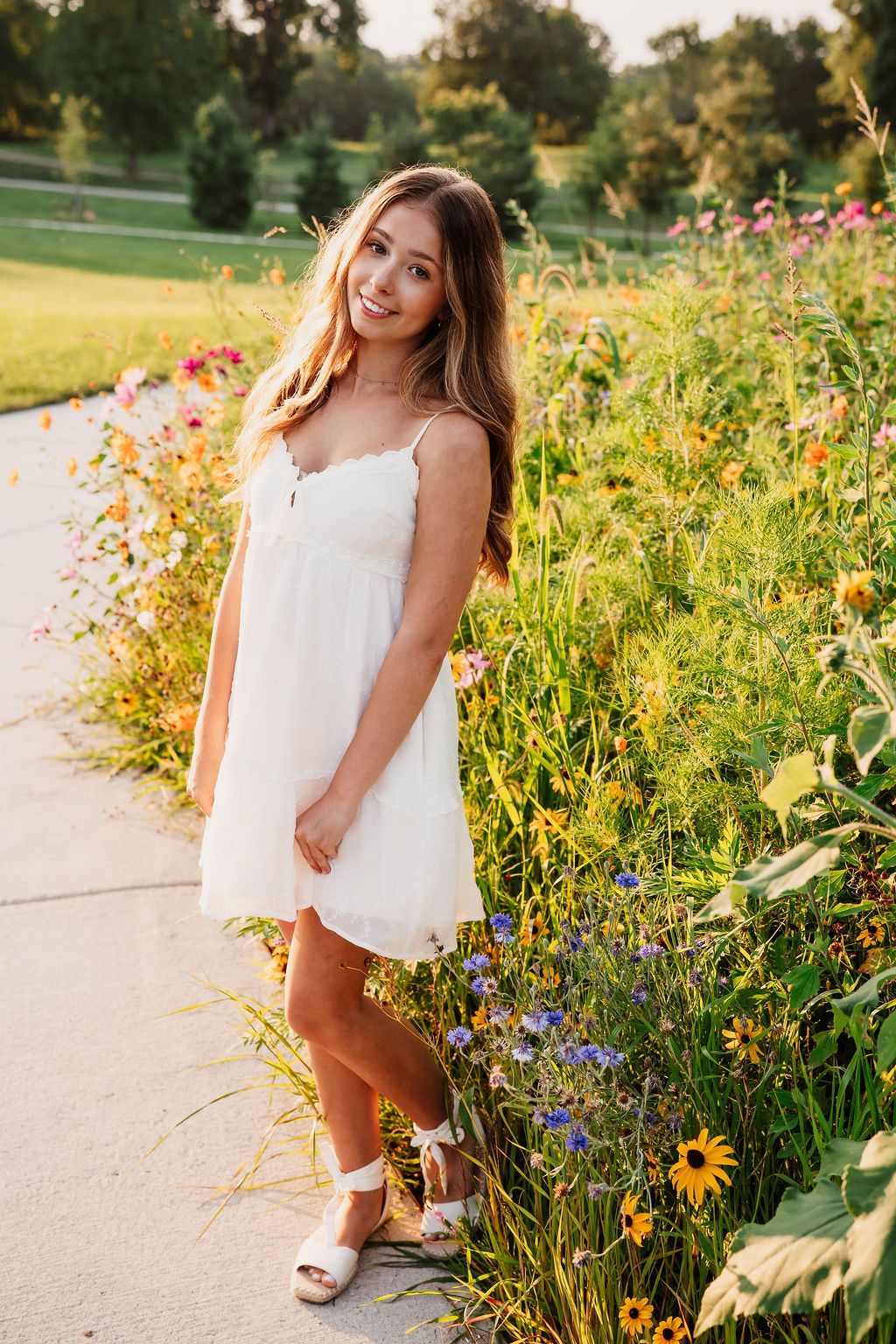 A series of summer portraits taken in a garden with wildflowers during golden hour.