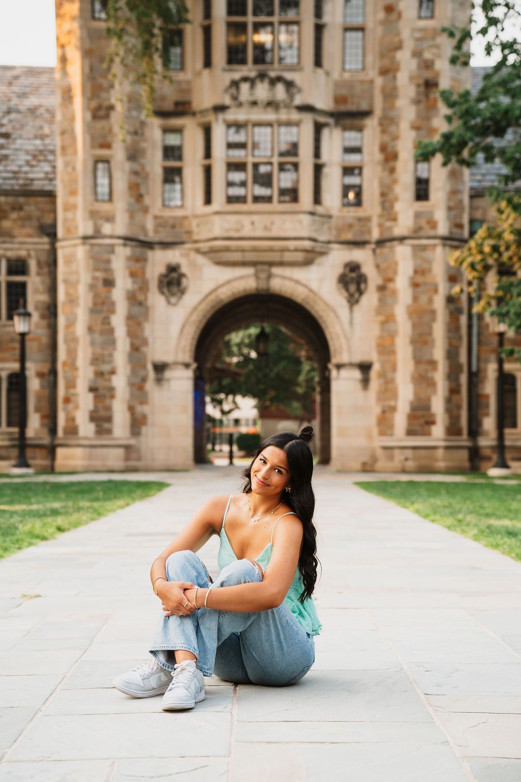 Casual lifestyle portraits on a university campus with gothic stone buildings and archways in the background.