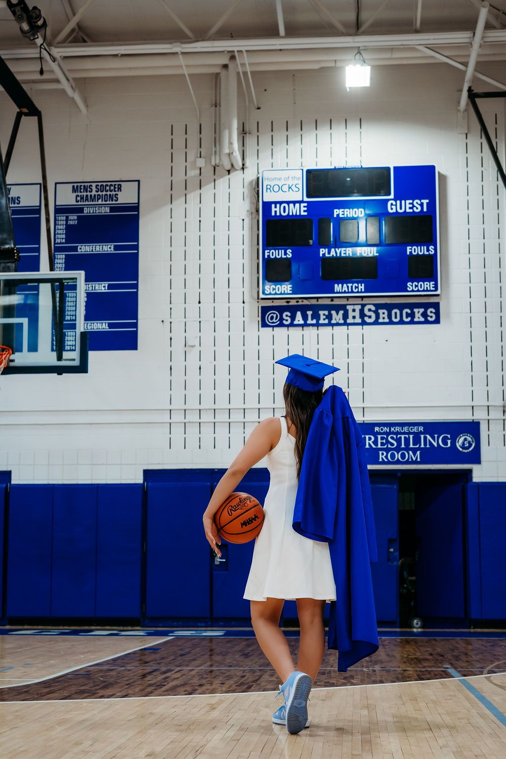 Four interior views of a high school gymnasium showing blue walls, hardwood floors, and basketball hoops.