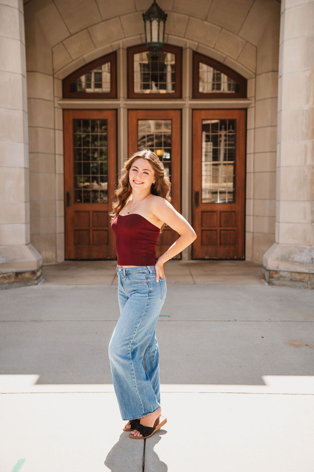 A photo series under stone archways featuring casual denim and architectural elements of a historic building.