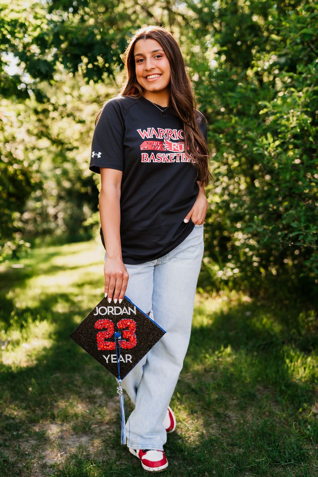 Person in black t-shirt and light jeans posing outdoors with Michael Jordan basketball-themed accessories.