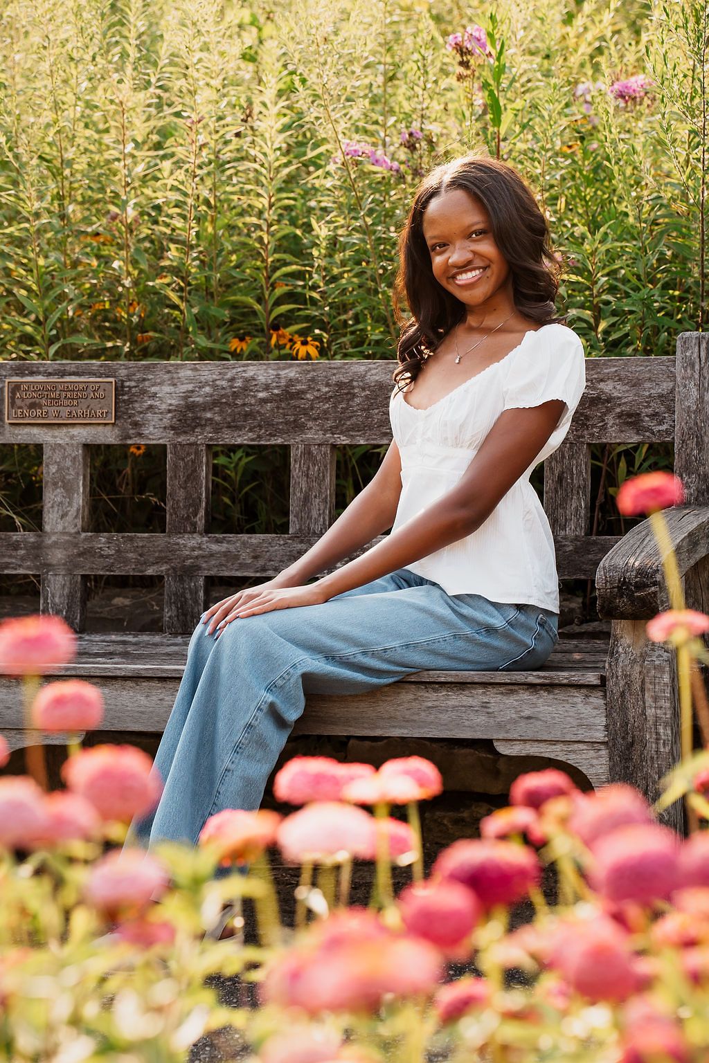 Summer garden portrait with pink flowers and natural wooden bench setting. Matthai Botanical Garden Senior photos