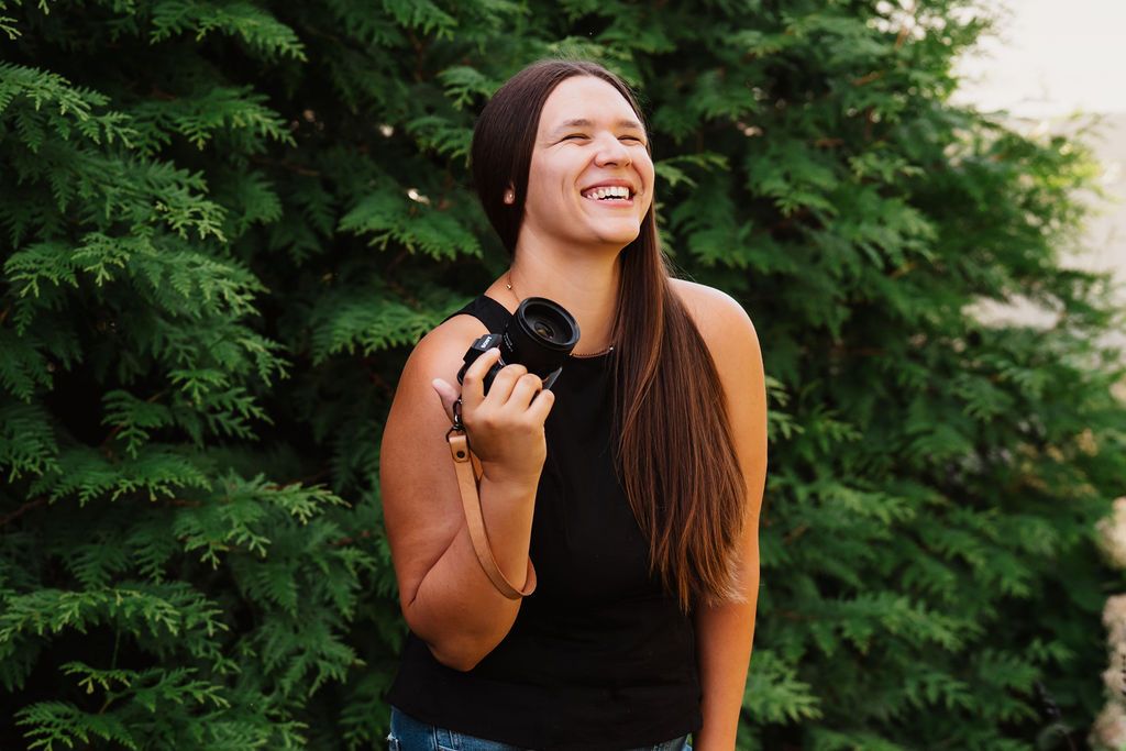Outdoor portrait session with natural greenery and trees in the background.