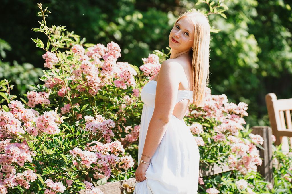 Romantic garden photoshoot with soft pink roses and natural lighting.