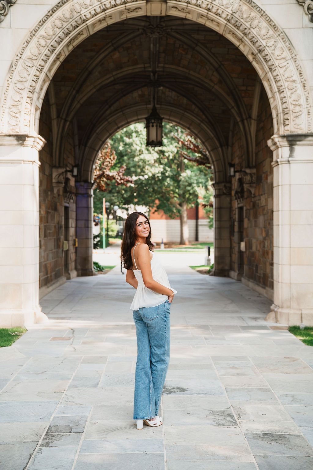 Stone archway corridor with elegant architectural details creates a dramatic perspective.
