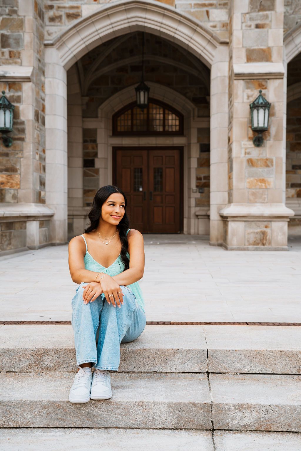 A series of casual portraits on stone steps with gothic architecture and arched doorways in the background.
