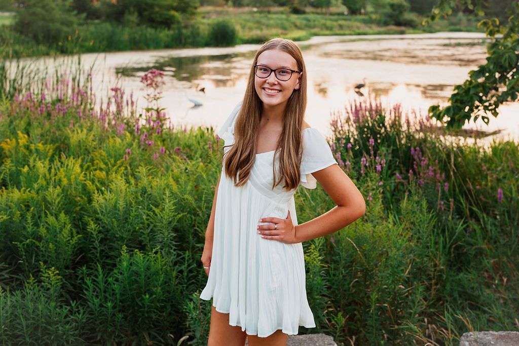 A summer portrait session in a field with wildflowers and natural sunlight.