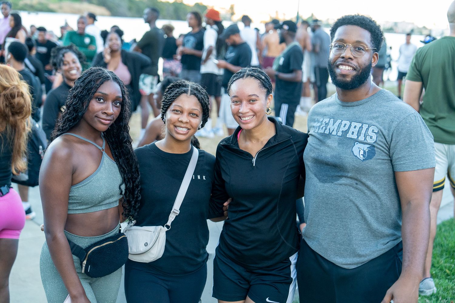 Happy participants smiling and enjoying a community fitness event outdoors.