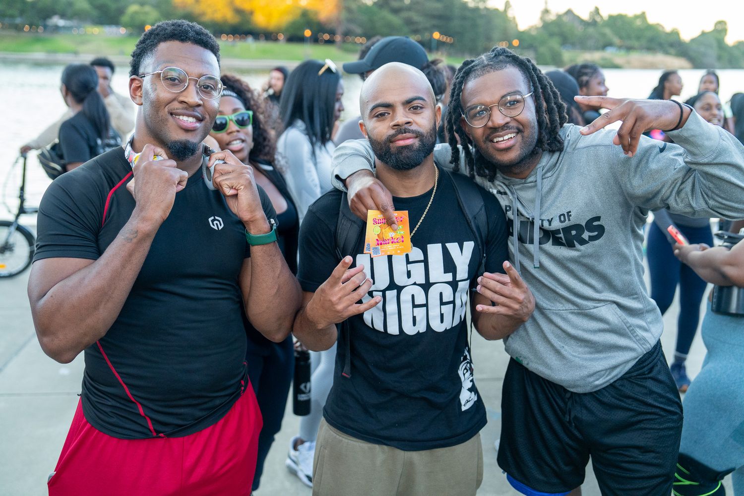 Energetic group participating in an outdoor community fitness gathering at sunset.