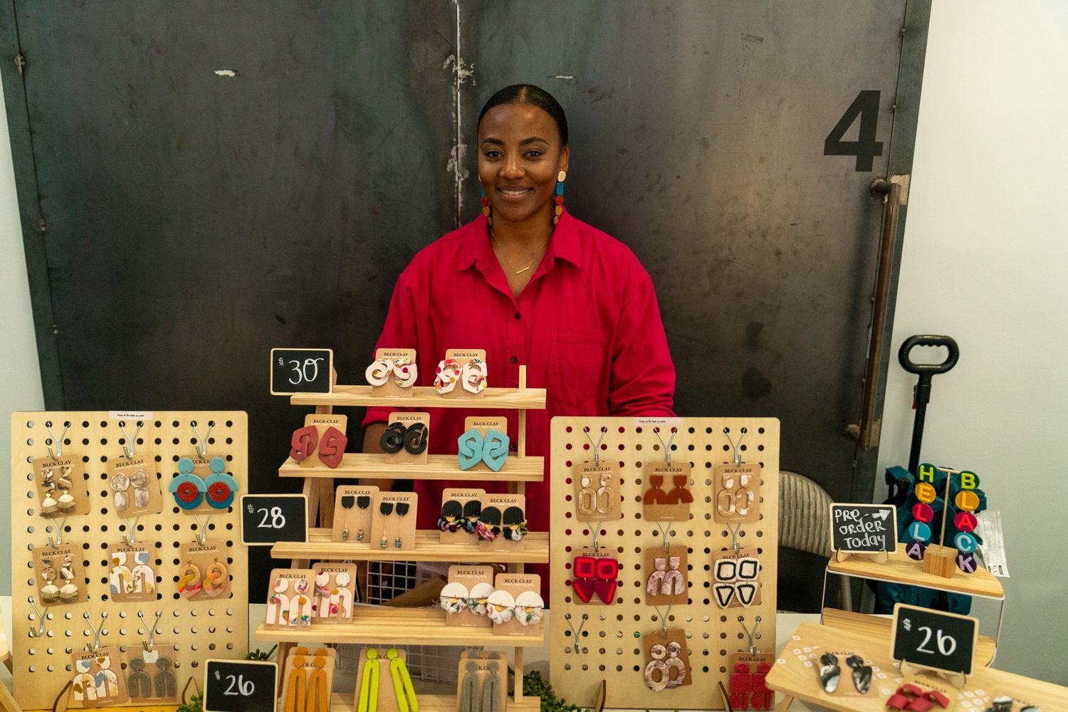 Wooden display cases showcase merchandise at a market vendor booth.