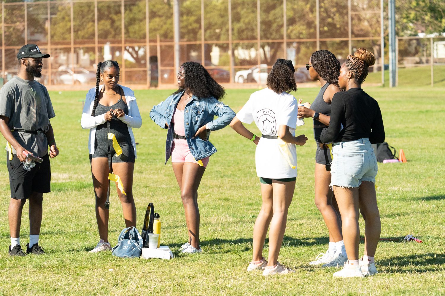 Row of participants lined up on grass field during outdoor activities.