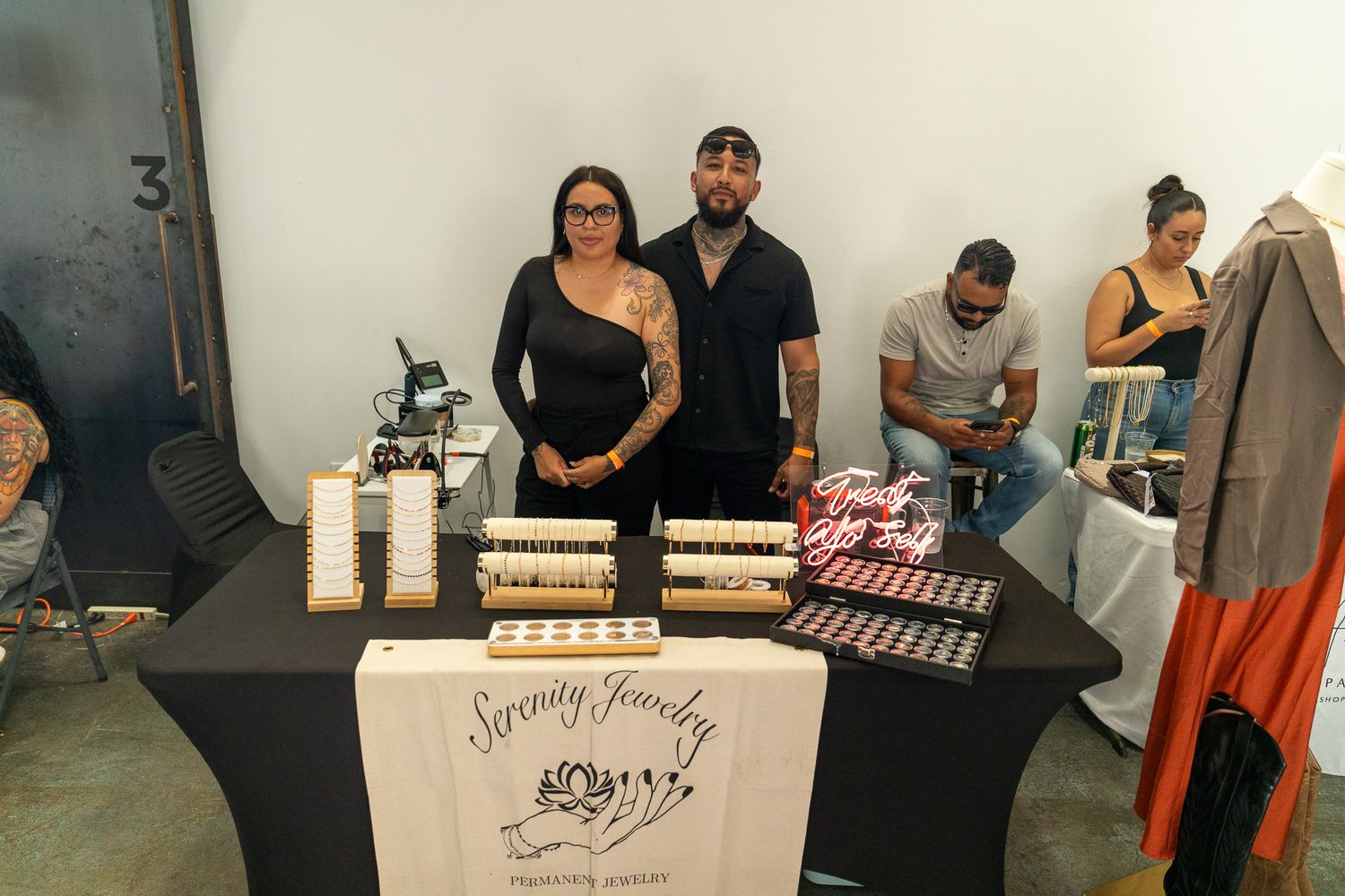 Vendors set up their display booths at an indoor market event.