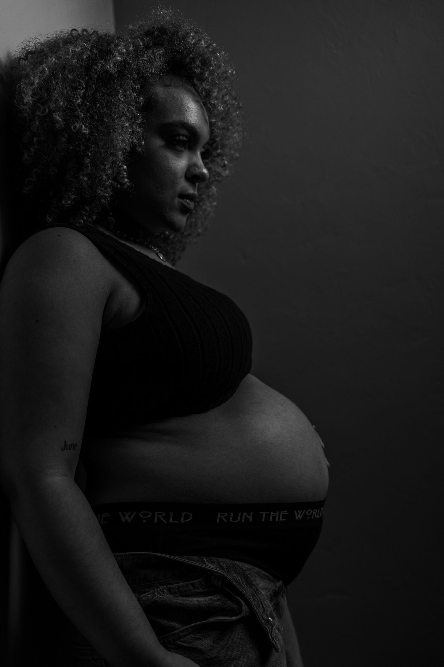 Artistic black and white portrait series showing curly hair silhouette against dark background.