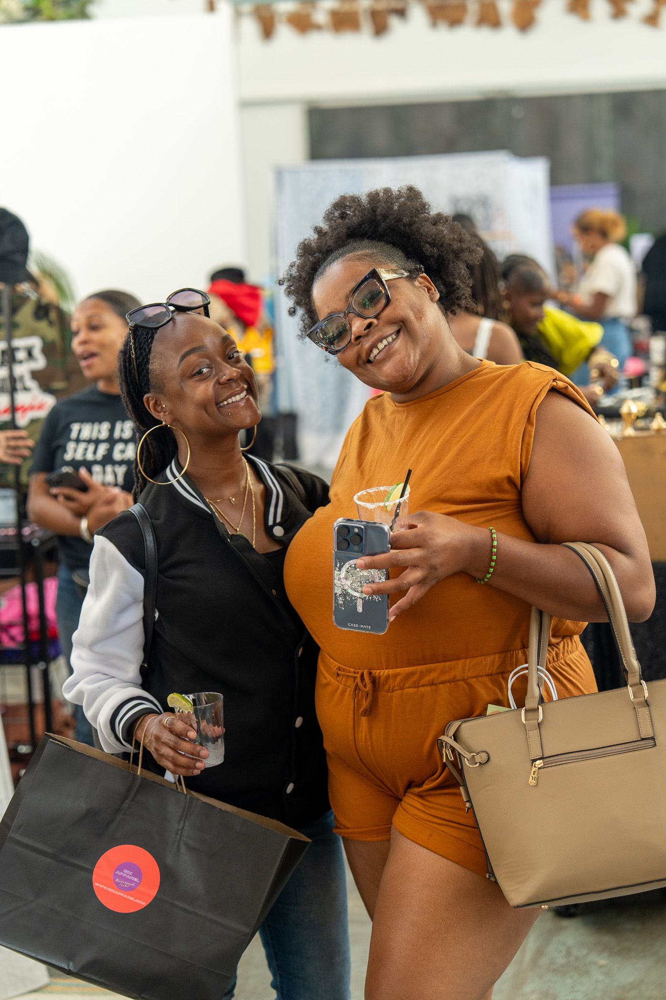 Friends share joyful moments of laughter and hugs at a social gathering.