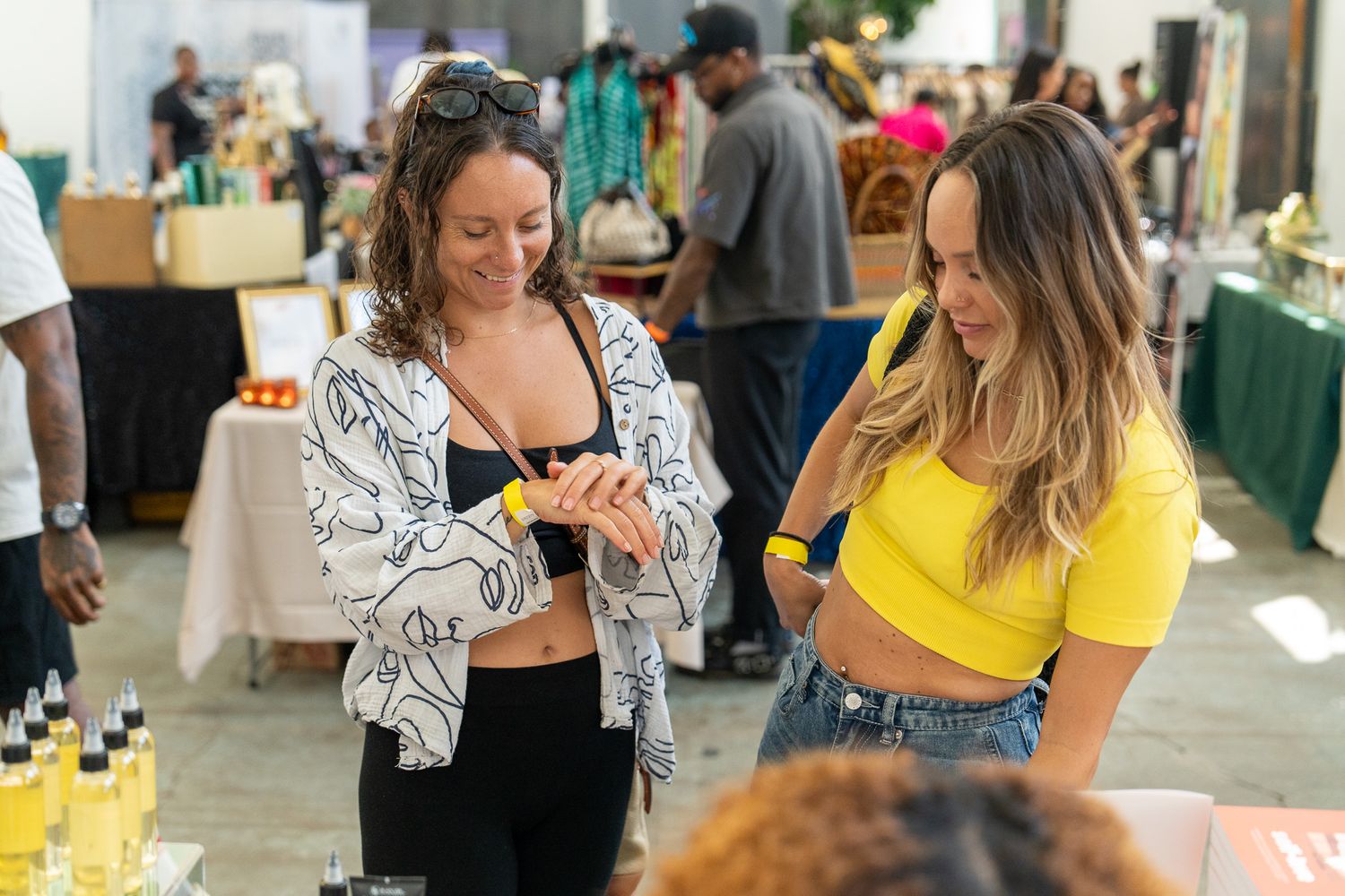 Attendees mingling at an indoor social gathering with bright lighting.