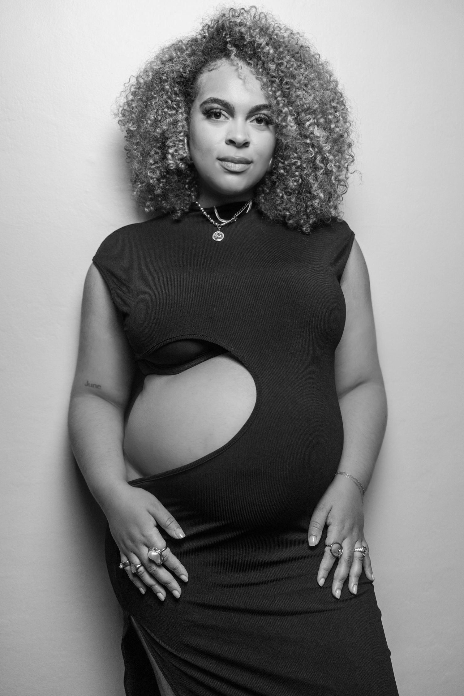 Black and white portrait series in fitted black top against white background.