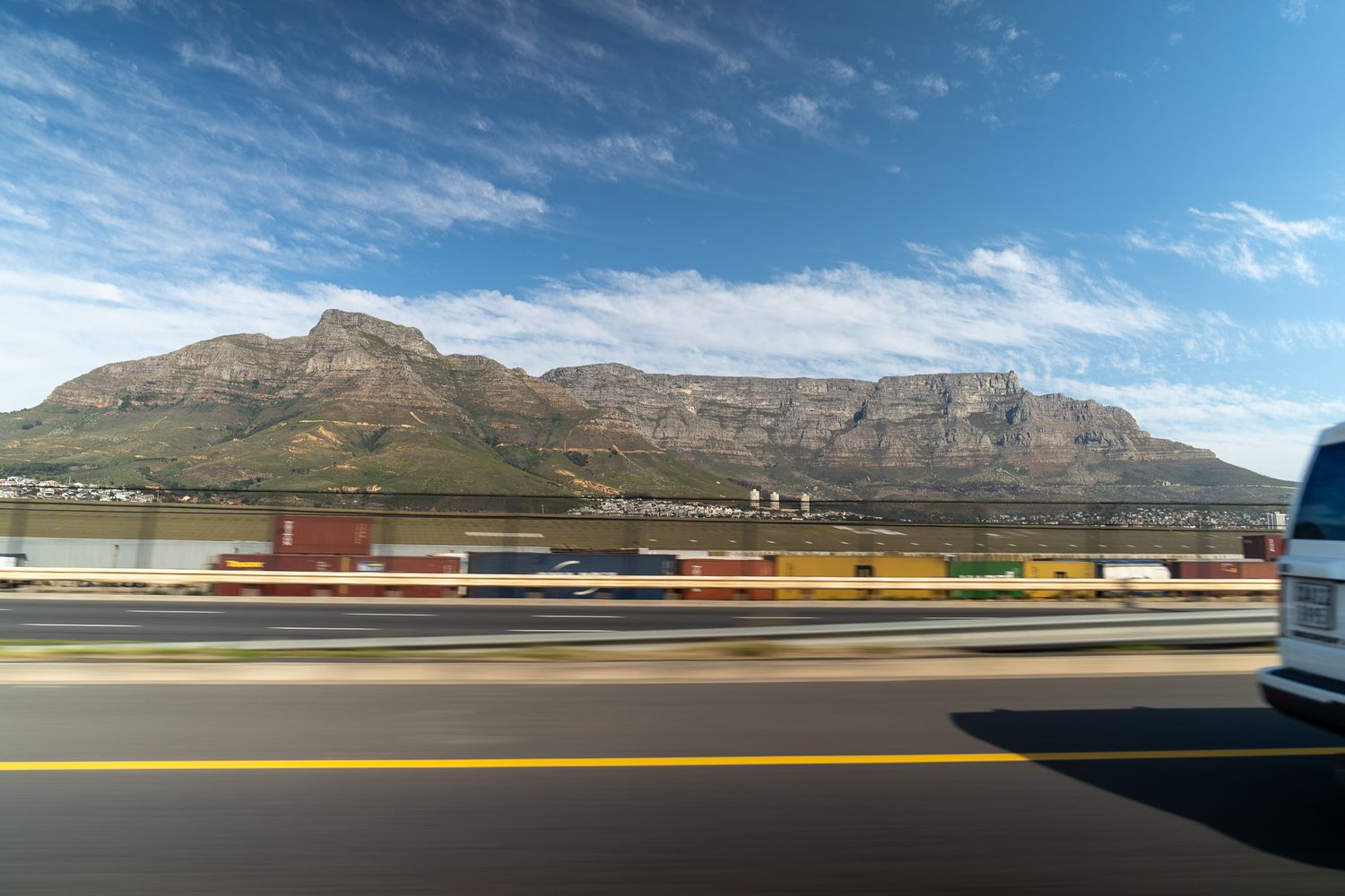 Mountain range stretches across the horizon with buildings visible in the foreground.