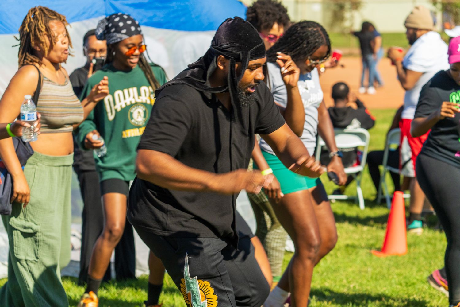 Participants gathering on a grassy field during an outdoor sports event.