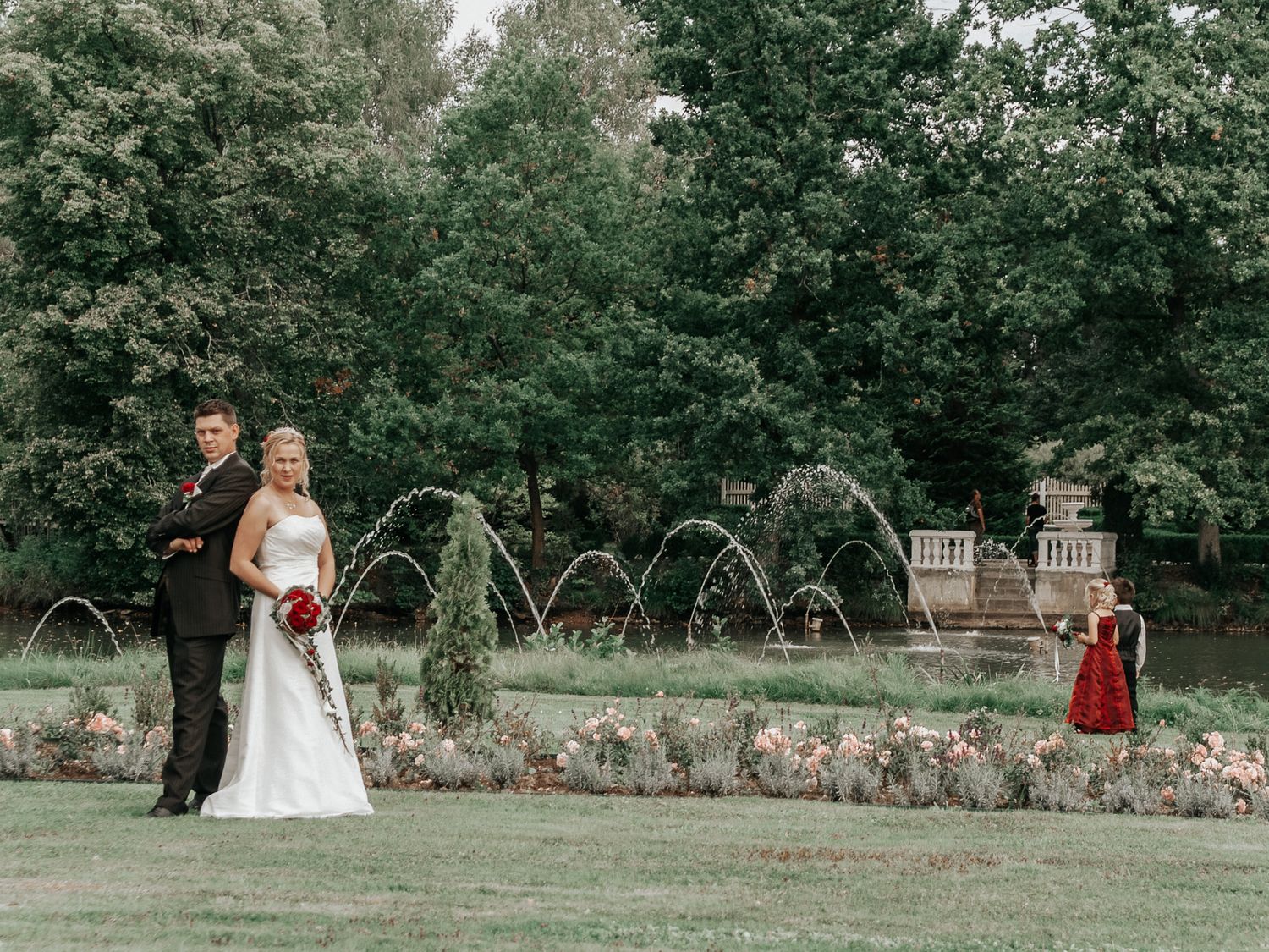 A series of wedding photos showing a couple in an outdoor garden setting with lush greenery and stone walls.