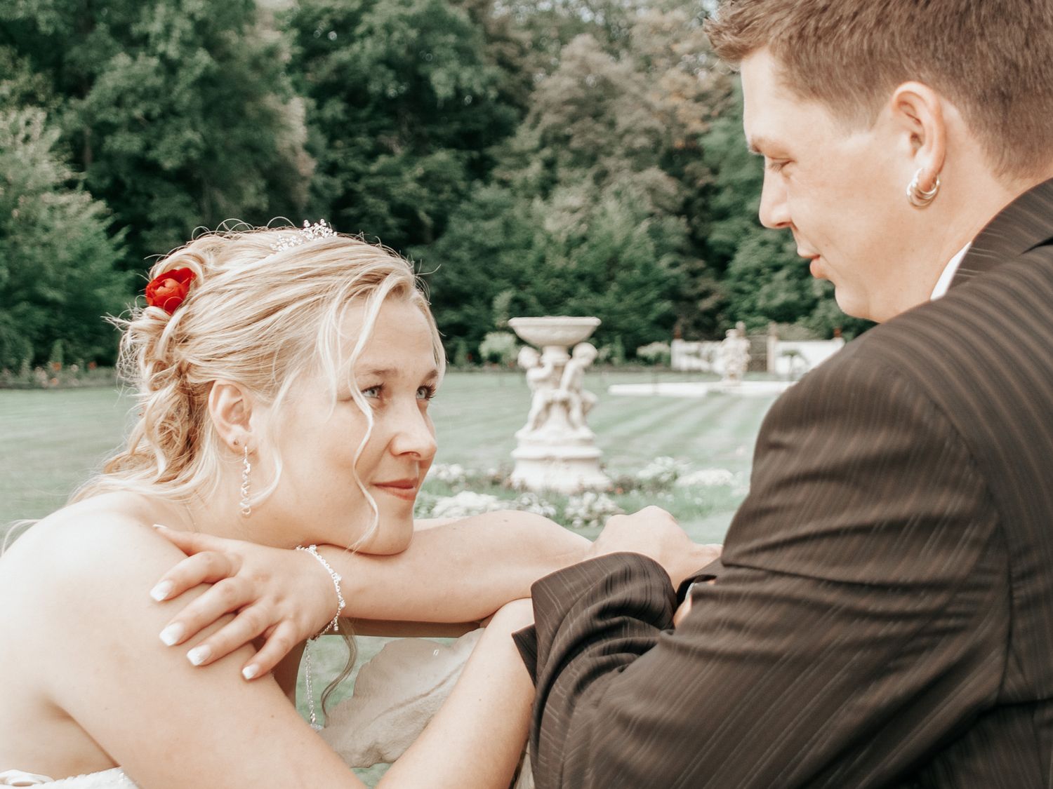 A romantic wedding photo sequence showing tender moments between a couple in an outdoor garden setting.