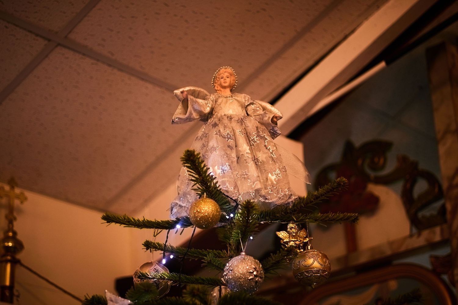 Christmas decorations and lights adorning a ceiling corner.