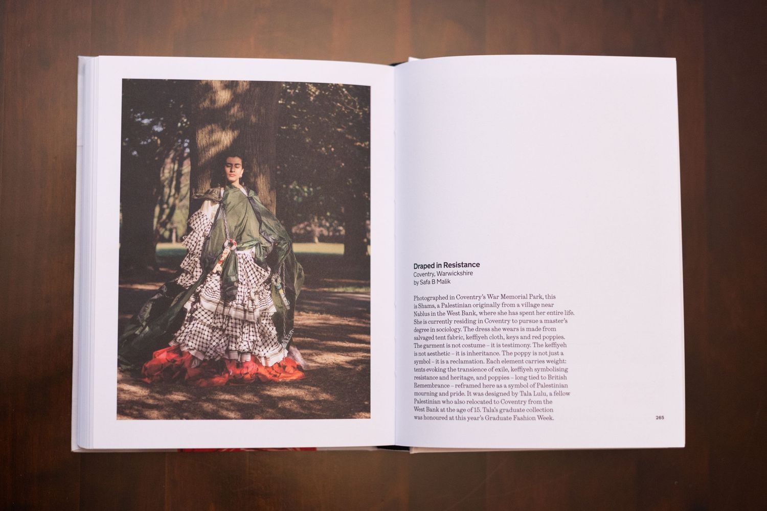 Open wedding photo album displaying artistic photography layouts on dark background.