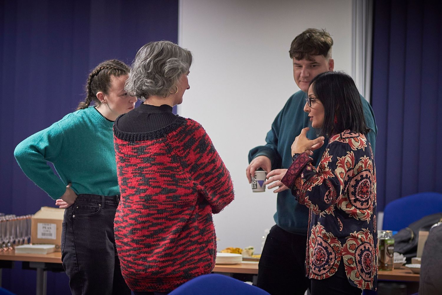 People in a class or workshop engage in interactive learning activities with focus on body movements and gestures.