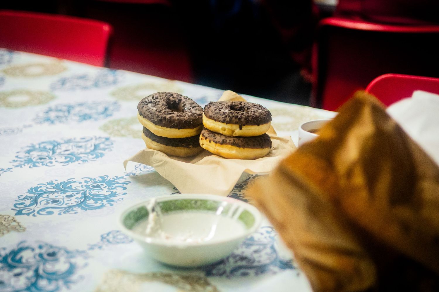 Dessert plates and cookies arranged on a blue patterned tablecloth.