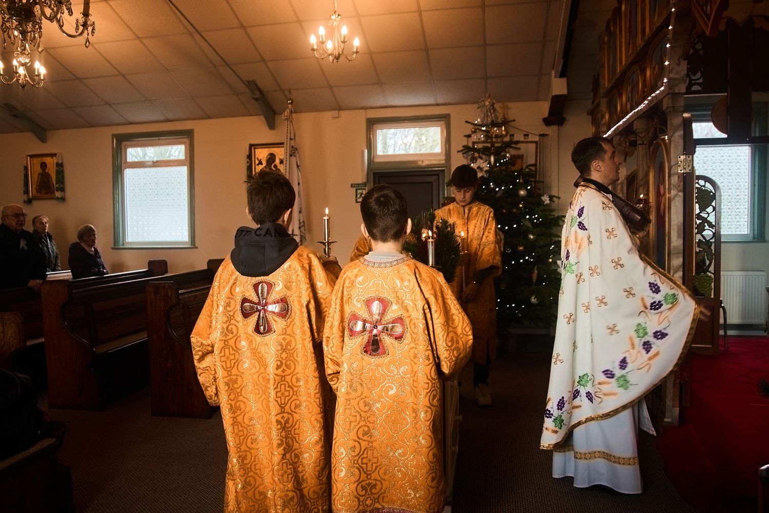 Golden Orthodox clergy robes adorned with decorative crosses and patterns shown in a church setting.