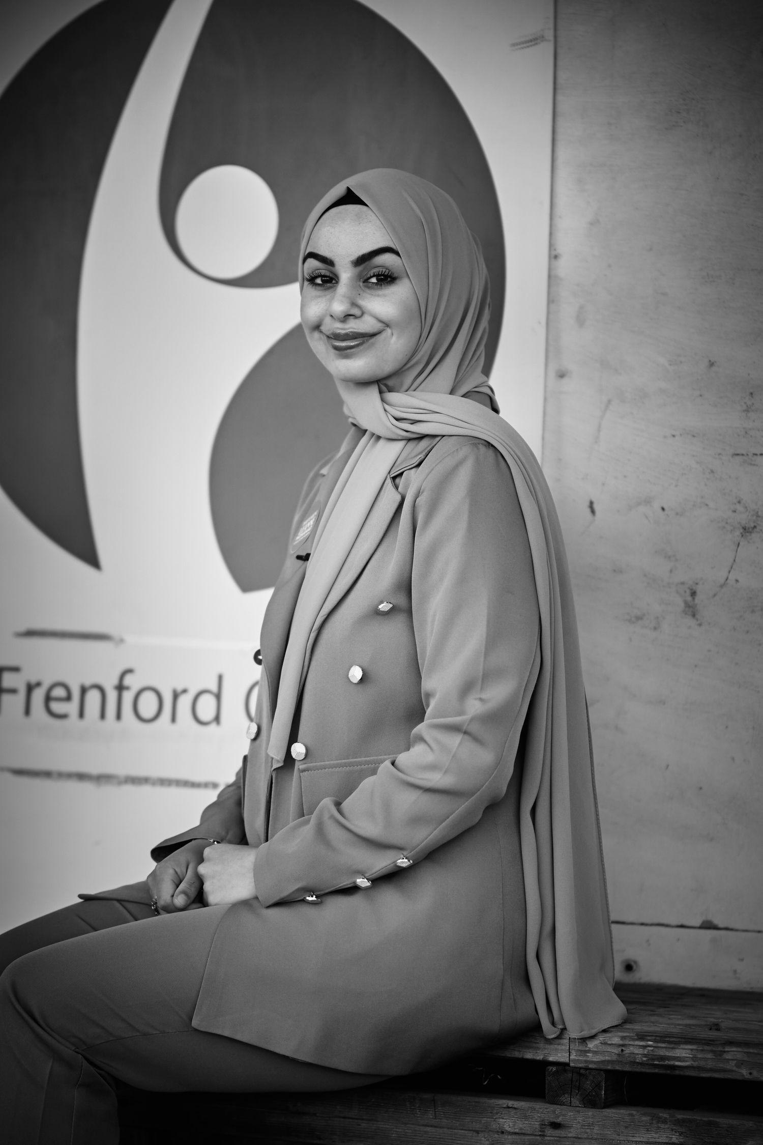 Black and white portrait series in front of a wall with Frenford logo.