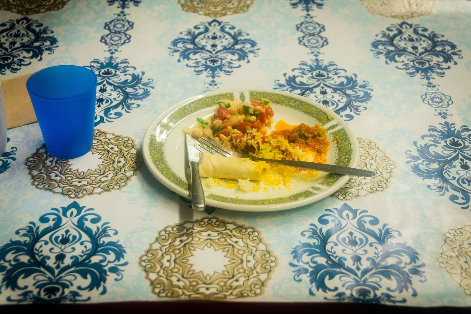 Plated desserts on an elegant blue and white patterned tablecloth at a dining event.