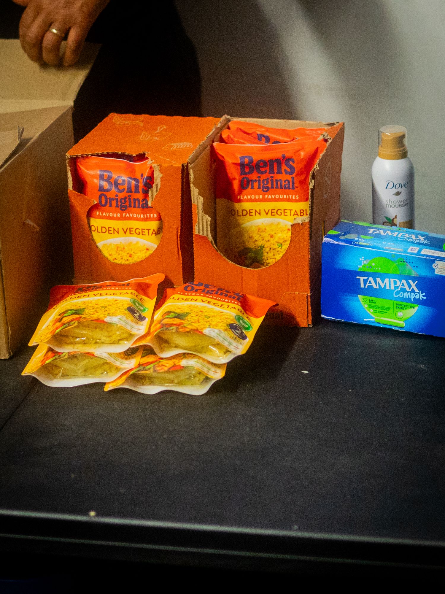 Ben's Original rice packages and personal care products arranged on a black table.