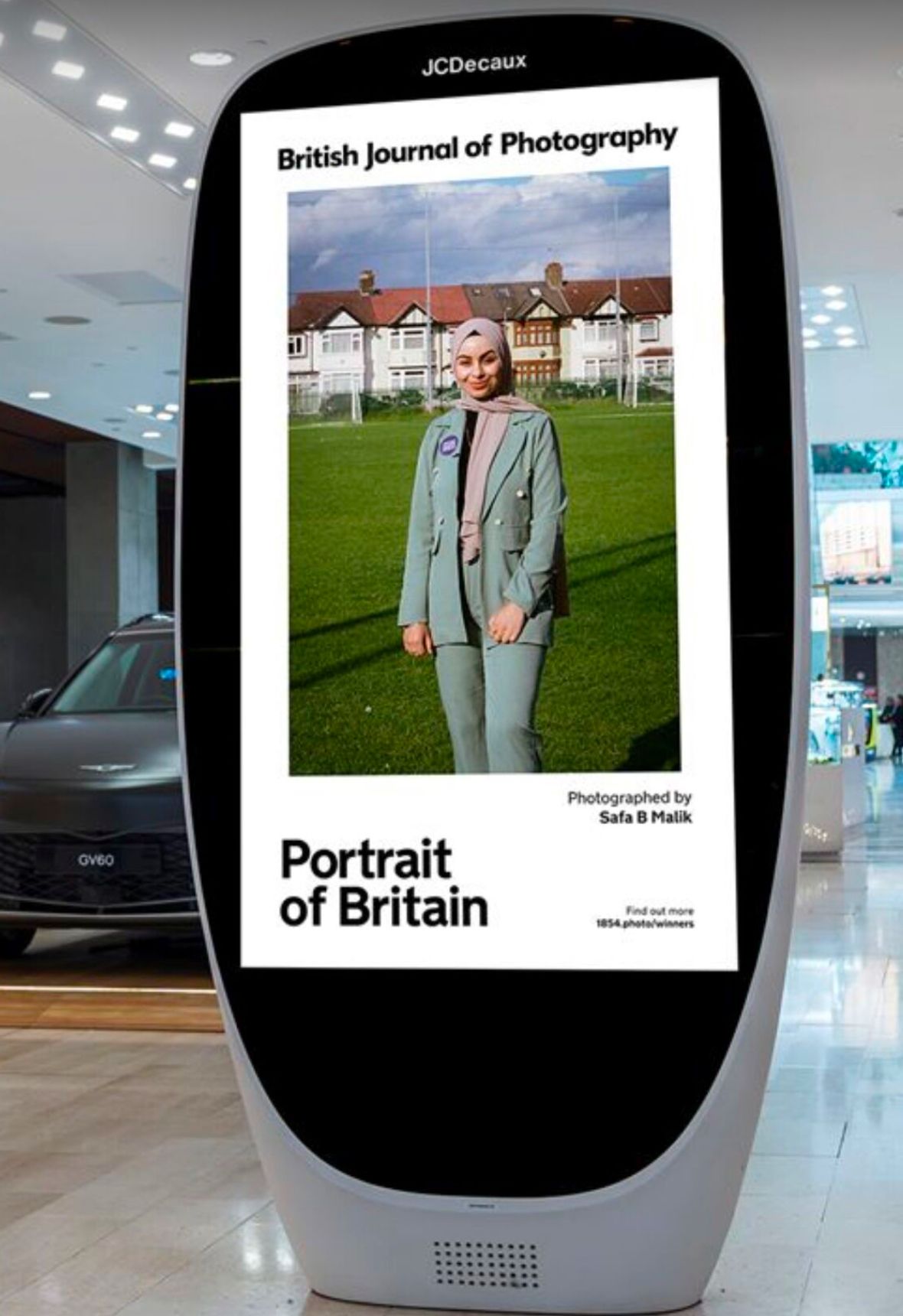 JCDecaux digital screens displaying British Journal of Photography exhibition content in a commercial space.