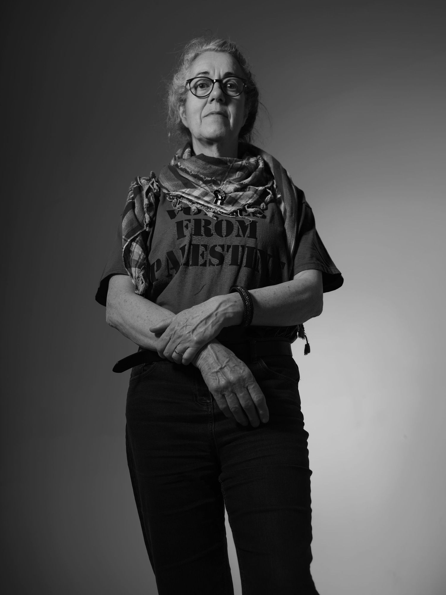 Black and white portrait showing person wearing protest message t-shirt.