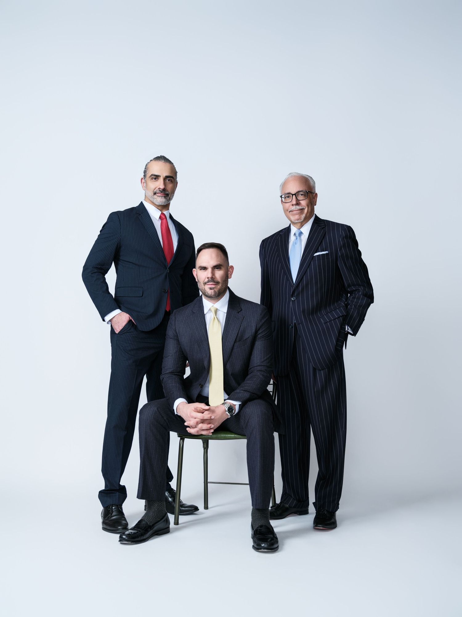 Studio business photoshoot with multiple poses against clean white background.