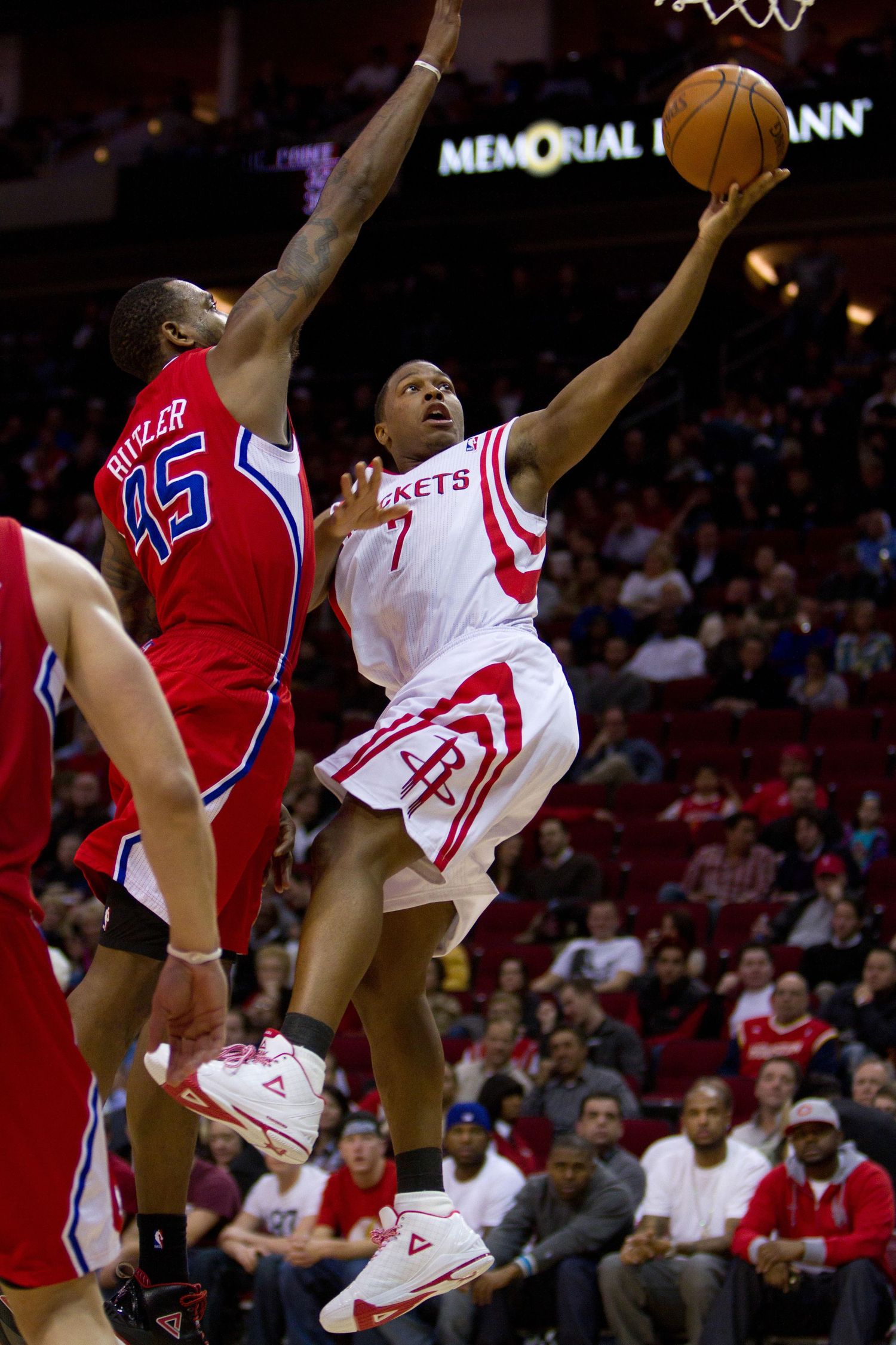 Basketball players leap for a rebound during an NBA game between Houston and LA.